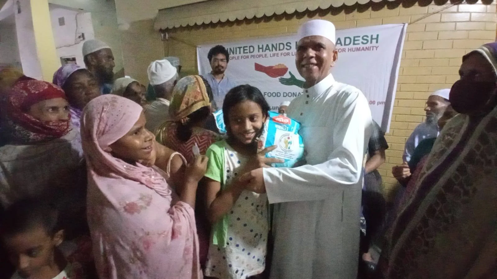 Leader distributing food to smiling children