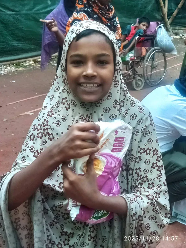 Smiling girl receiving food assistance